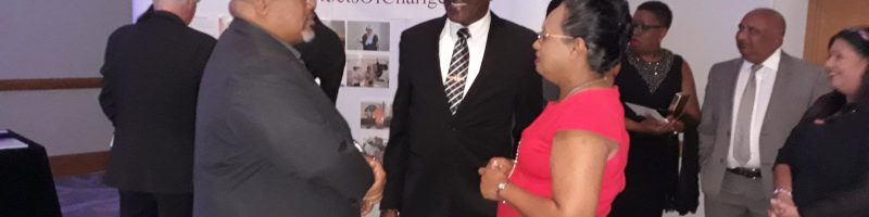 Housing Minister, Major General (Retired) Edmund Dillon in conversation with Mr. Derwin Howell, Chairman of Habitat Trinidad and Tobago and Ms. Jennifer Massiah, National Director, Habitat Trinidad and Tobago in the forefront of the photo taken at Habitat Trinidad and Tobago’s Hunger Banquet, 2019 at the Hyatt Regency.