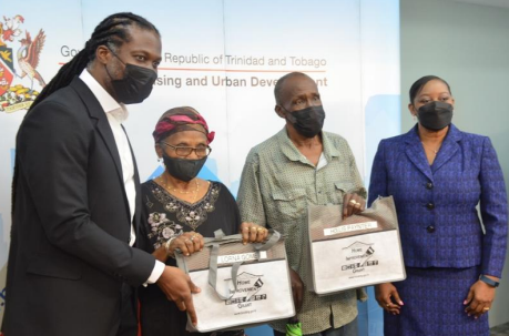 Minister Leonce presents Home Improvement Grants to Recipients at a  Cheque Distribution Ceremony